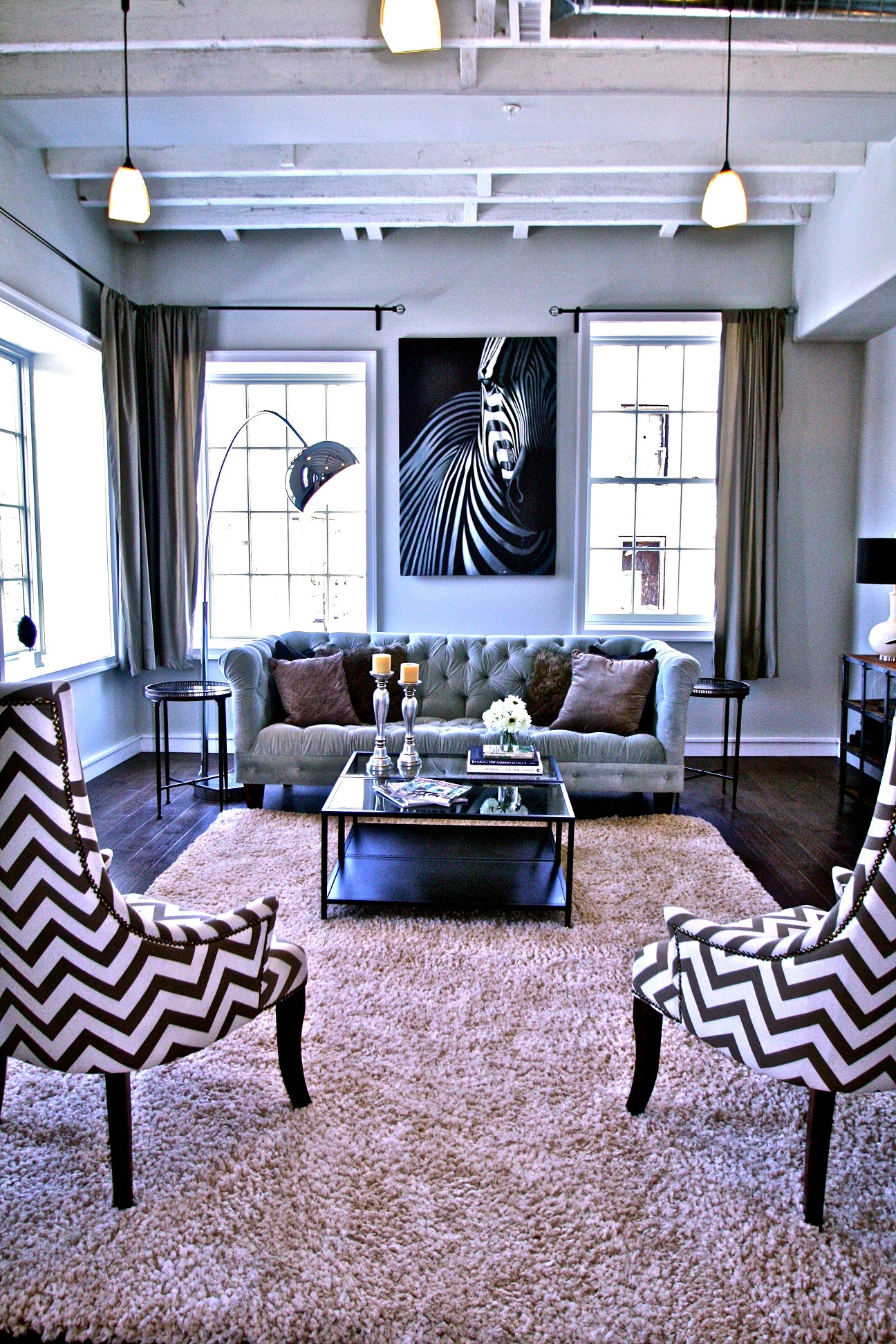 a living room with zebra print chairs and a couch